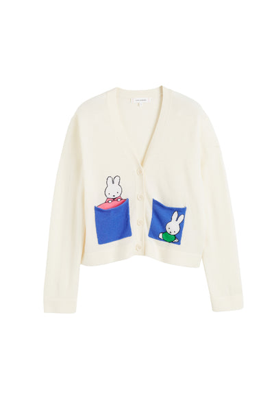 White cardigan with cartoon character patches on a white background