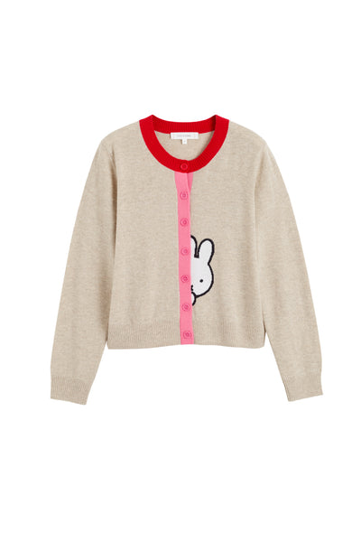 Beige sweater with red trim and a cartoon character on a white background