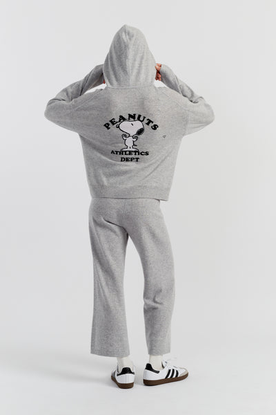 Person wearing a grey 'Peanuts Athletics Dept.' hoodie and pants on a white background