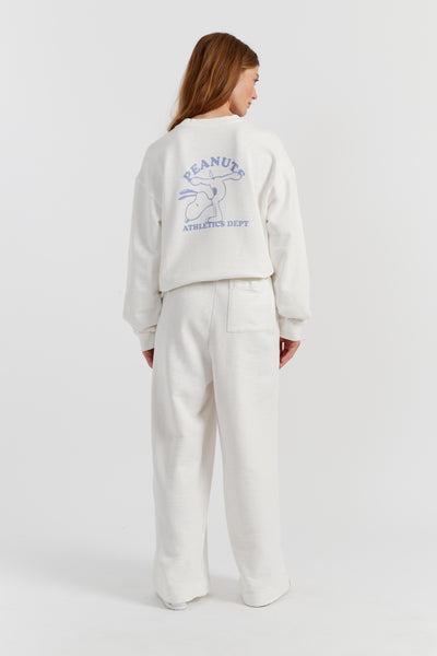 Person wearing a white sweatshirt with a logo on the back against a white background