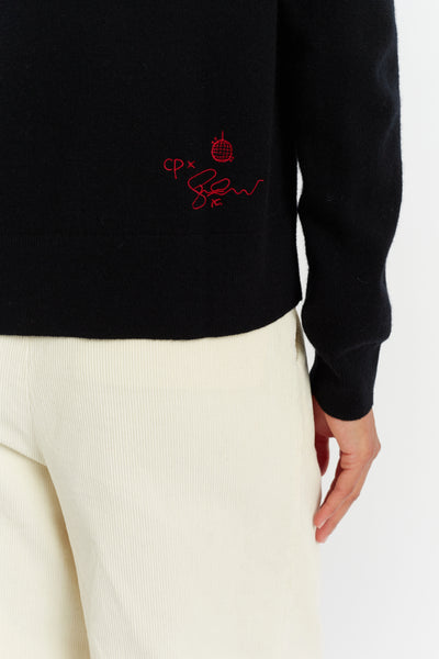 Black sweater with red embroidery on a white background
