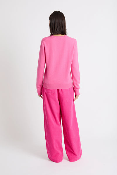 Person wearing a pink pajama set on a white background