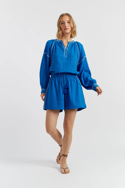 Woman wearing a blue outfit on a white background