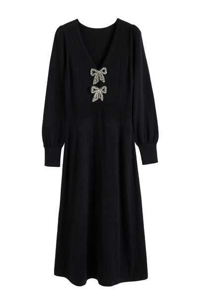 Black dress with bow details on a white background