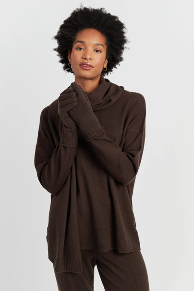 Woman wearing a brown outfit with a matching scarf on a white background