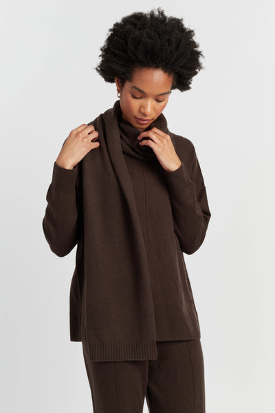 Woman wearing a brown outfit against a white background