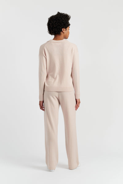 Person wearing a beige outfit on a white background