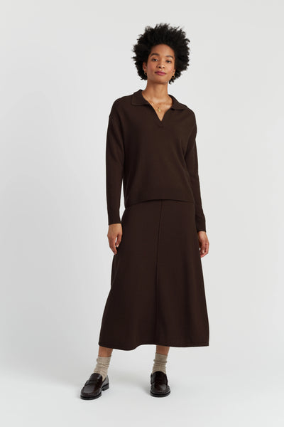 Person wearing a brown outfit on a white background