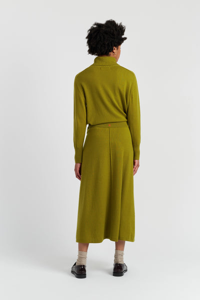 Person wearing a green outfit on a white background
