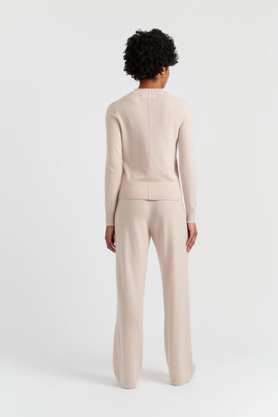 Person wearing a beige suit on a white background