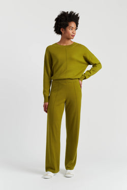Person wearing a green outfit on a white background