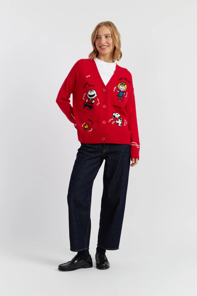 Woman wearing a red cardigan with cartoon character designs on a white background