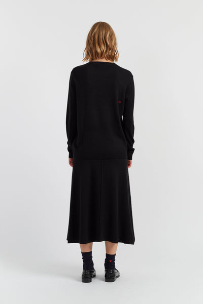 Person wearing a black dress on a white background