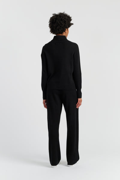 Person wearing a black outfit on a white background